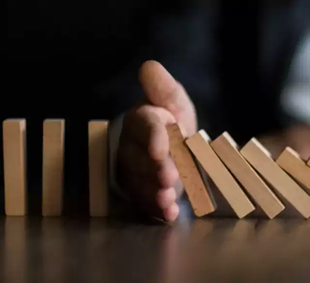 Hand holding back dominoes